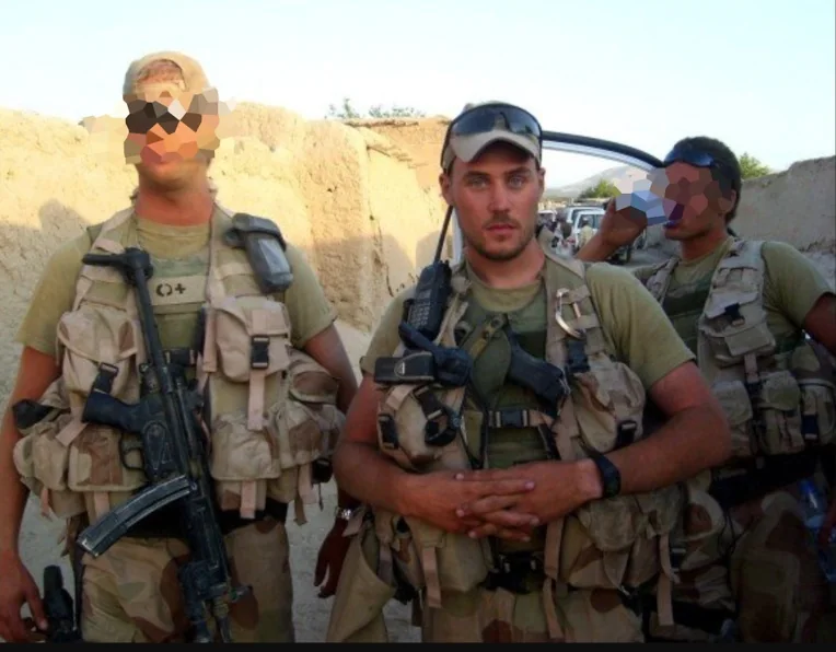 Jo in uniform with fellow soldiers; their faces are blurred
